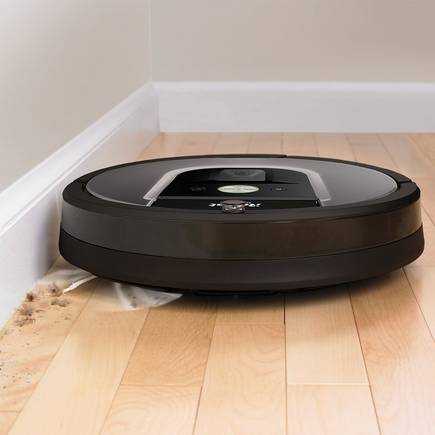 A roomba cleaning the edge of a wall